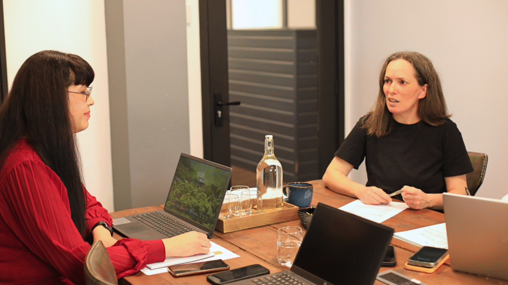 Two business women in the Pheonix Media Marketing boardroom