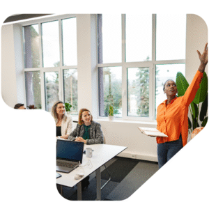Woman in orange presenting in an office