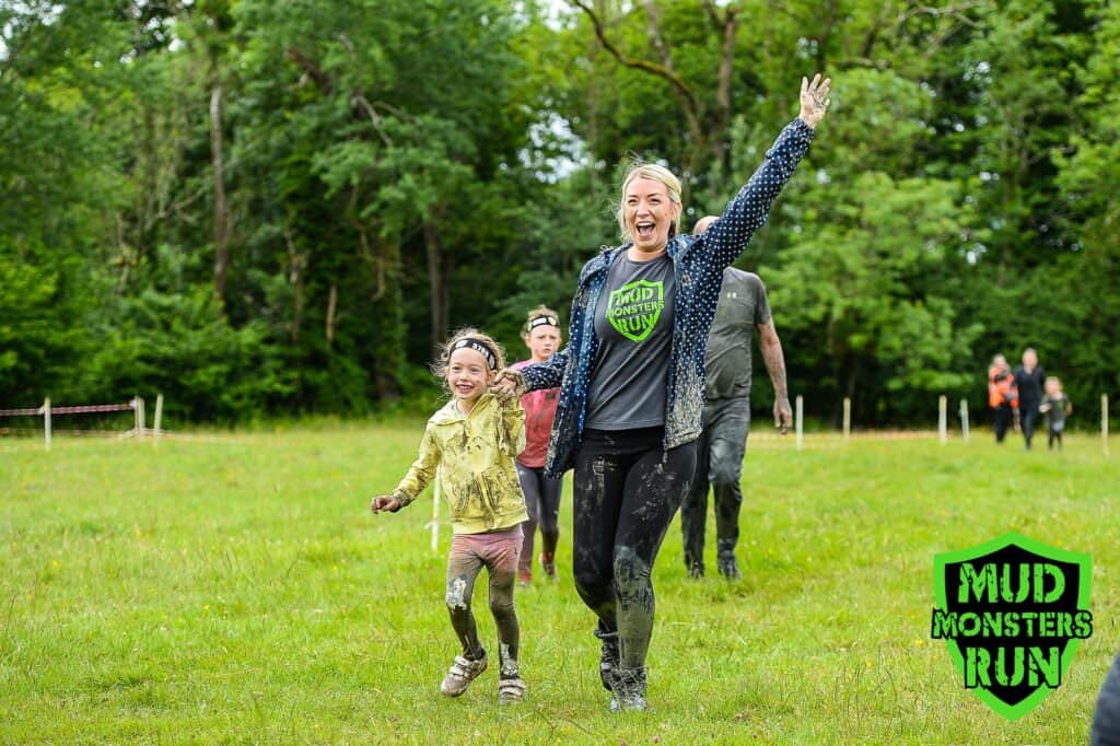 Children and adults enjoying muddy fun at Mud Monsters Run event.