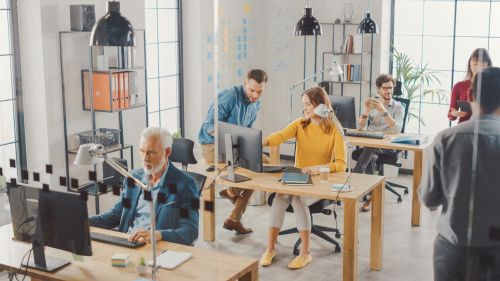 Team working together in a modern, open-plan office environment.